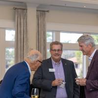 Bill Coderre standing in conversation with two other guests